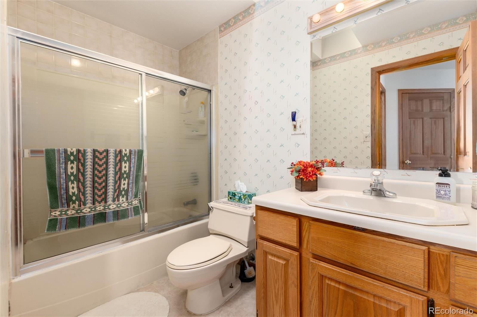 10650 Yellowstone Road Longmont, CO 80504 - Photo 30 of 43 a bathroom with a sink toilet and shower