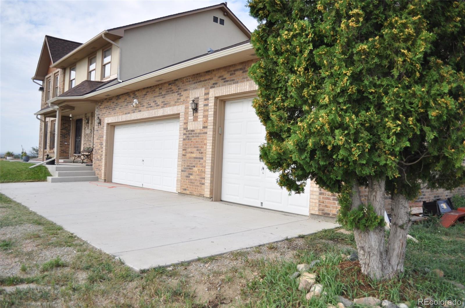 10650 Yellowstone Road Longmont, CO 80504 - Photo 4 of 43 a front view of a house with a yard and garage