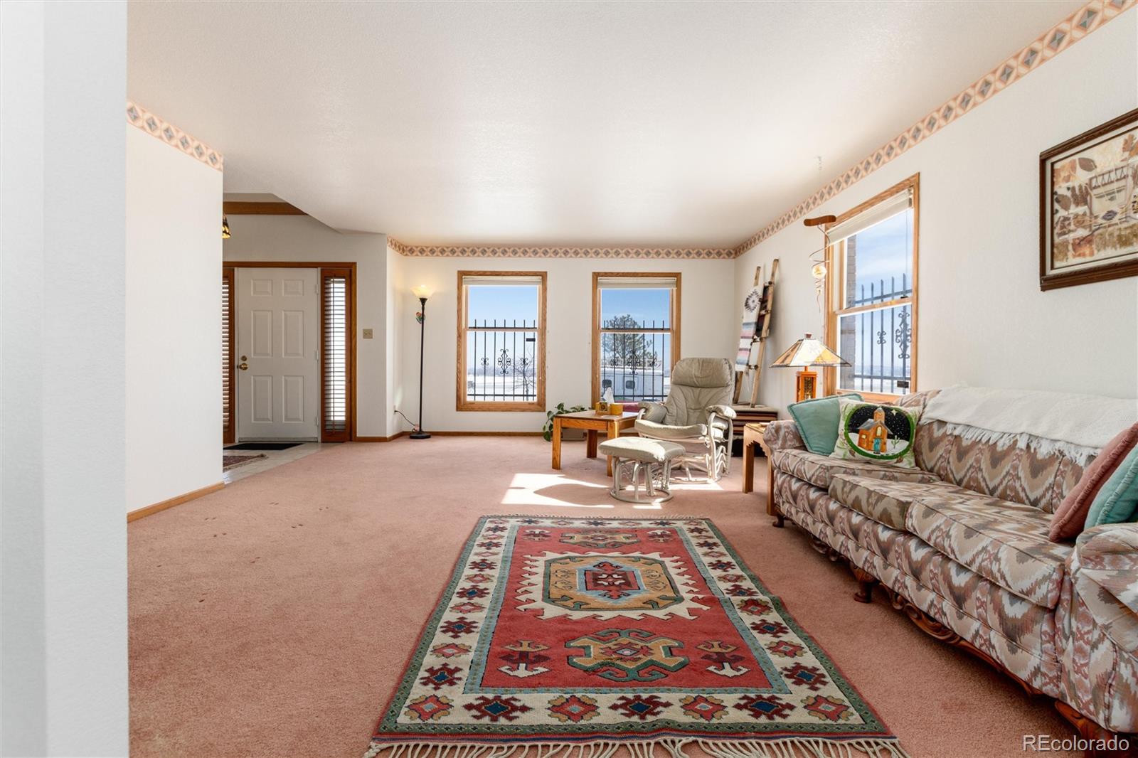 10650 Yellowstone Road Longmont, CO 80504 - Photo 9 of 43 a living room with furniture and a rug