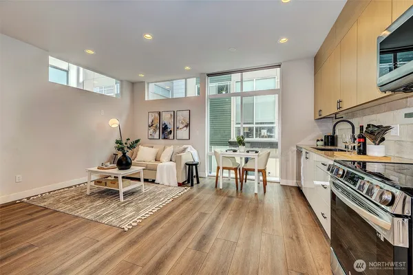 a living room with furniture and a wooden floor
