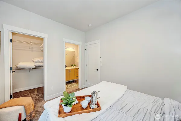 a bedroom with a bed and hallway