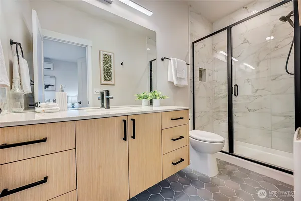 a bathroom with a double vanity sink toilet and shower