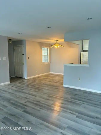 a view of a room with wooden floor and a window