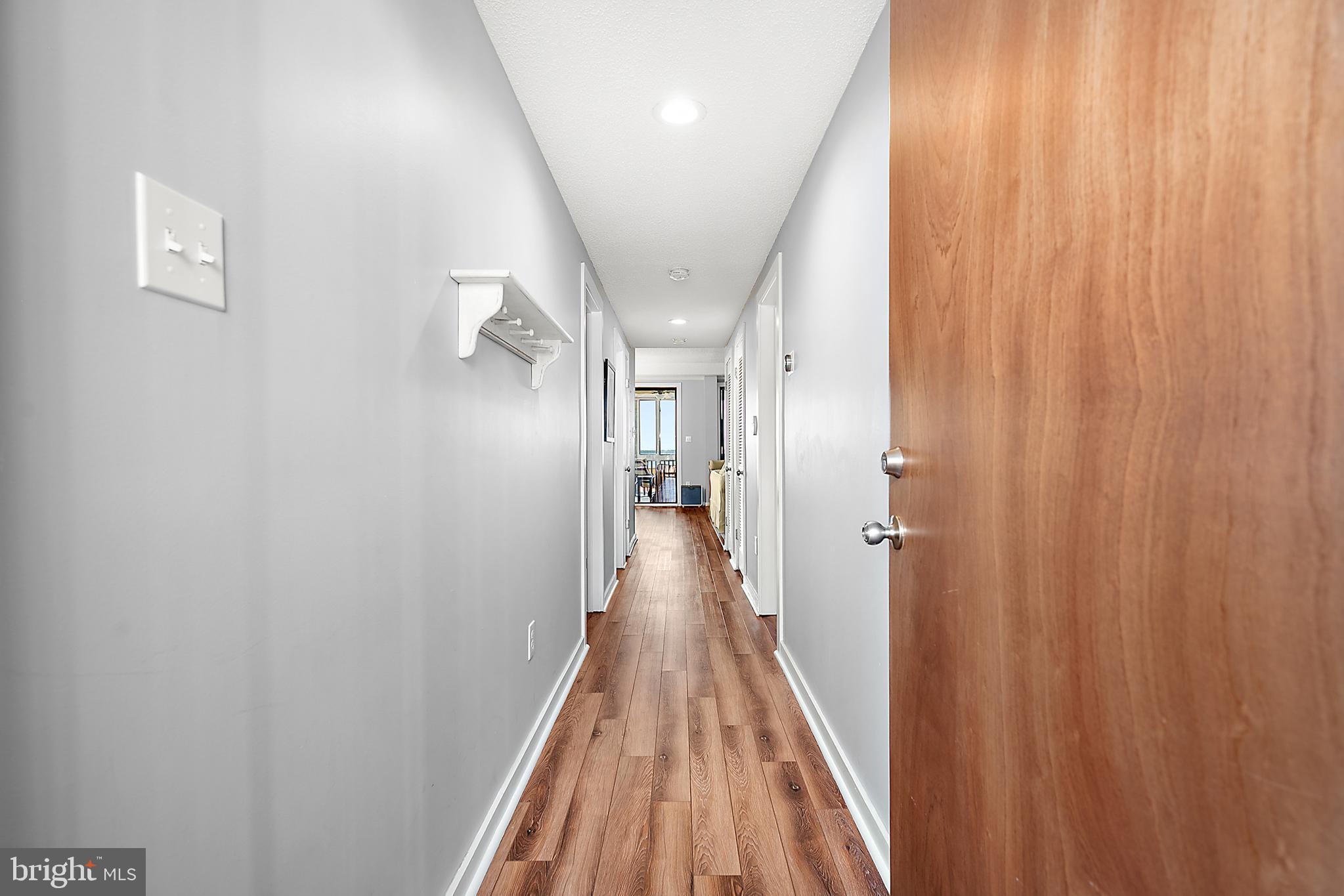 119 Old Landing Road, Unit 302B Ocean City, MD 21842 - Photo 13 of 46 a view of a hallway with wooden floor and staircase