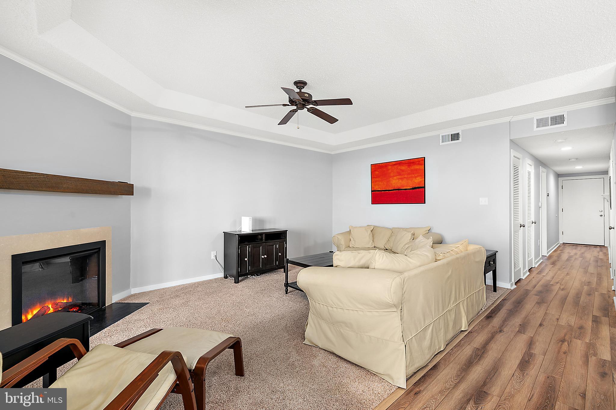 119 Old Landing Road, Unit 302B Ocean City, MD 21842 - Photo 14 of 46 a living room with furniture and a fireplace