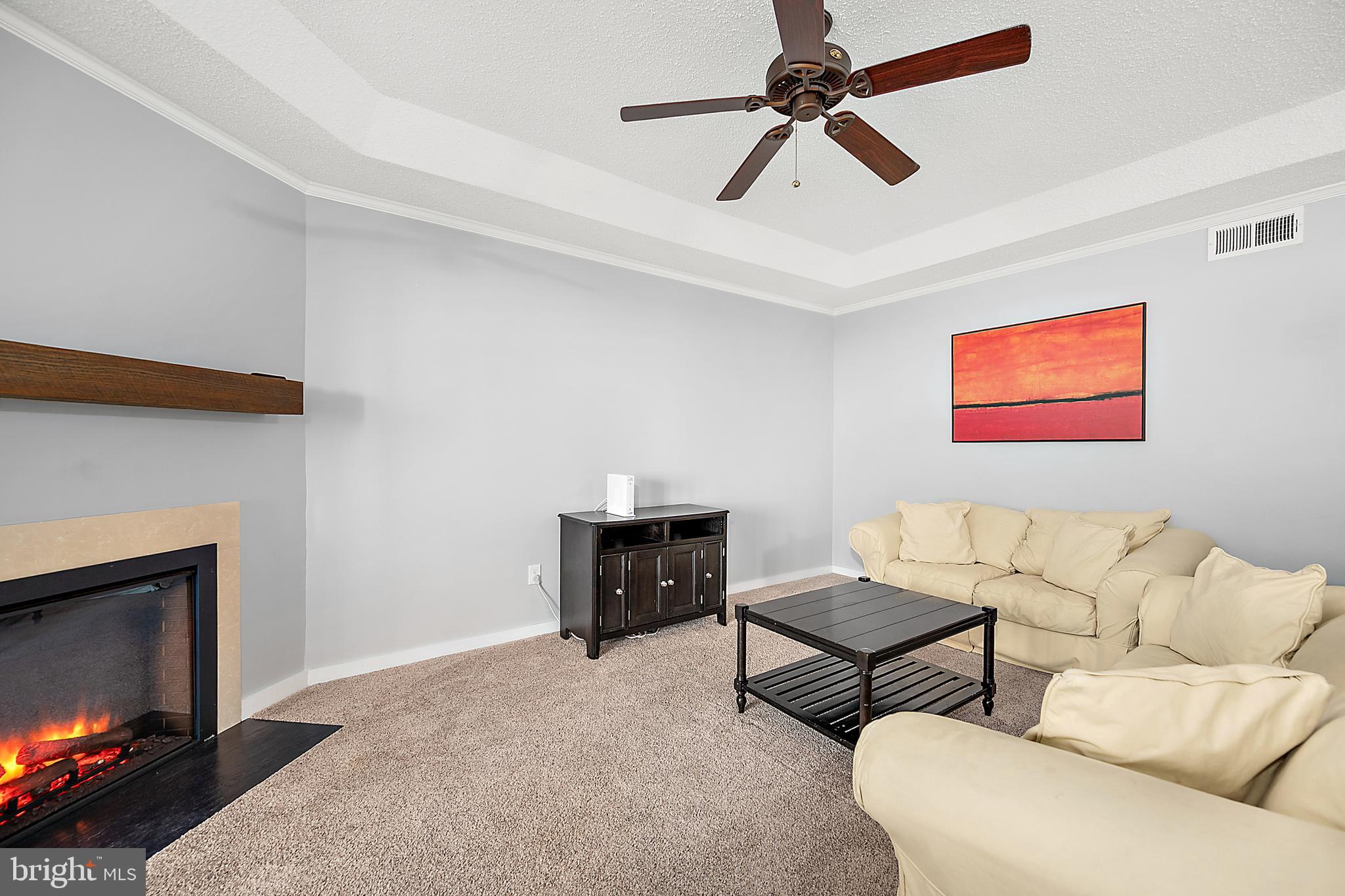 119 Old Landing Road, Unit 302B Ocean City, MD 21842 - Photo 15 of 46 a living room with furniture and a fireplace