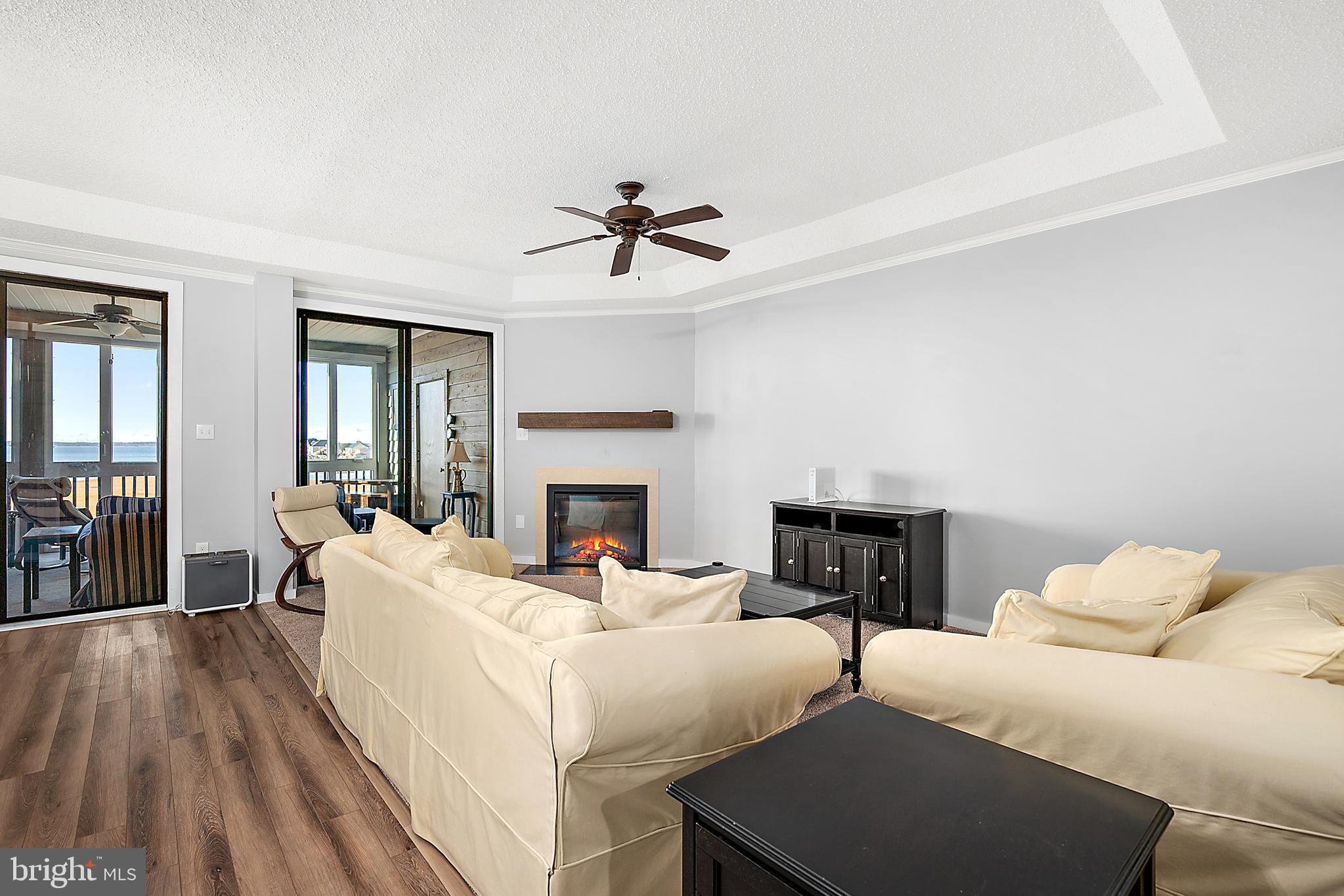 119 Old Landing Road, Unit 302B Ocean City, MD 21842 - Photo 18 of 46 a living room with furniture fireplace and flat screen tv