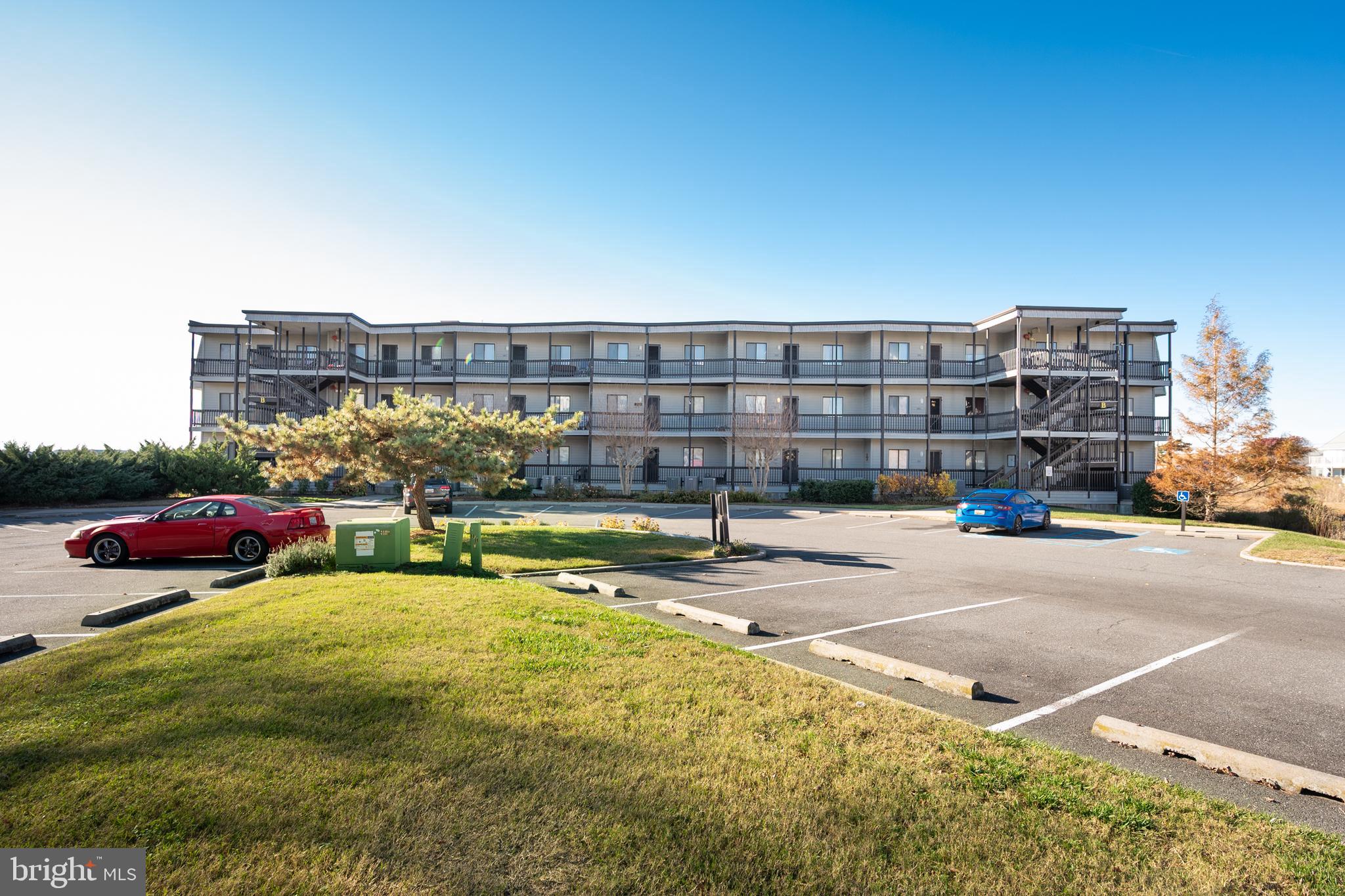 119 Old Landing Road, Unit 302B Ocean City, MD 21842 - Photo 2 of 46 a view of swimming pool with outdoor seating and a buildings view