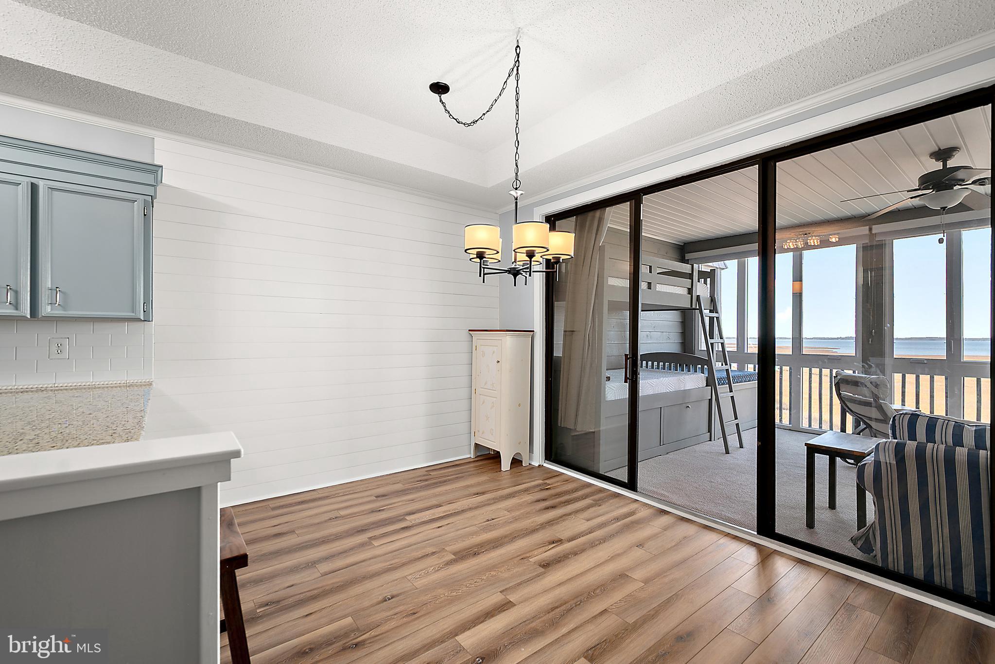 119 Old Landing Road, Unit 302B Ocean City, MD 21842 - Photo 22 of 46 a bedroom with a bed and wooden floor