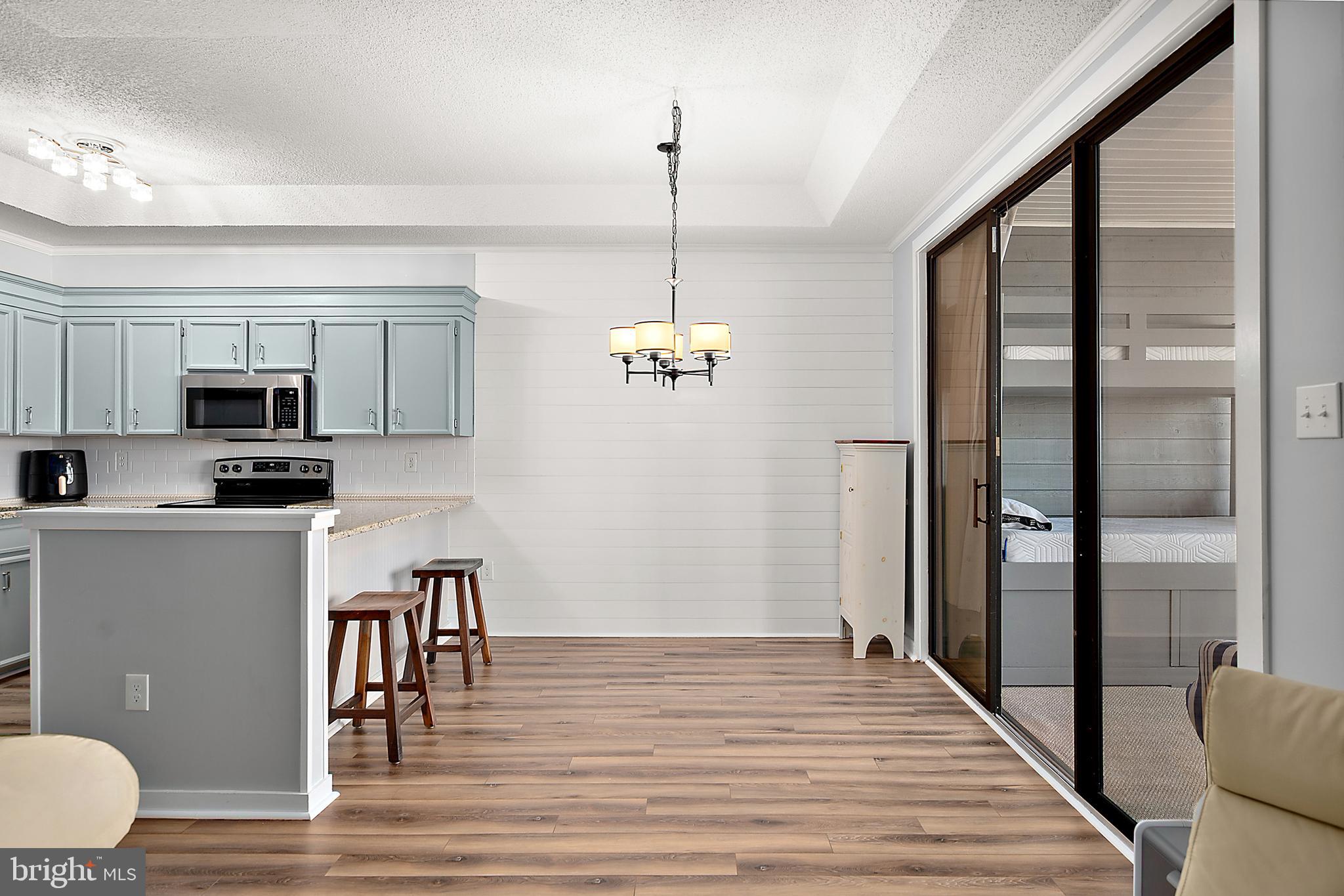 119 Old Landing Road, Unit 302B Ocean City, MD 21842 - Photo 23 of 46 a view of dining room with wooden floor
