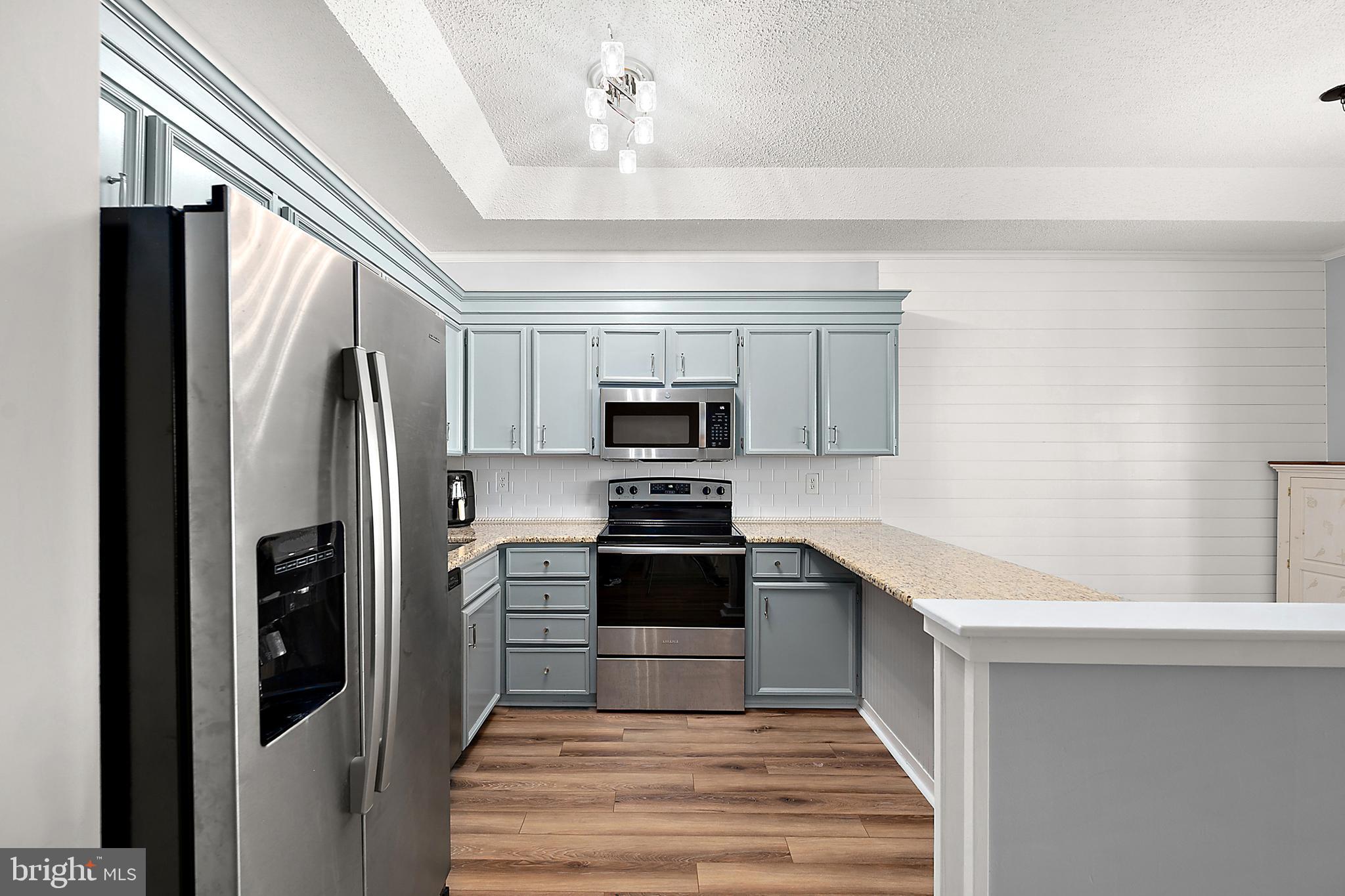 119 Old Landing Road, Unit 302B Ocean City, MD 21842 - Photo 26 of 46 a kitchen with stainless steel appliances a refrigerator stove and microwave