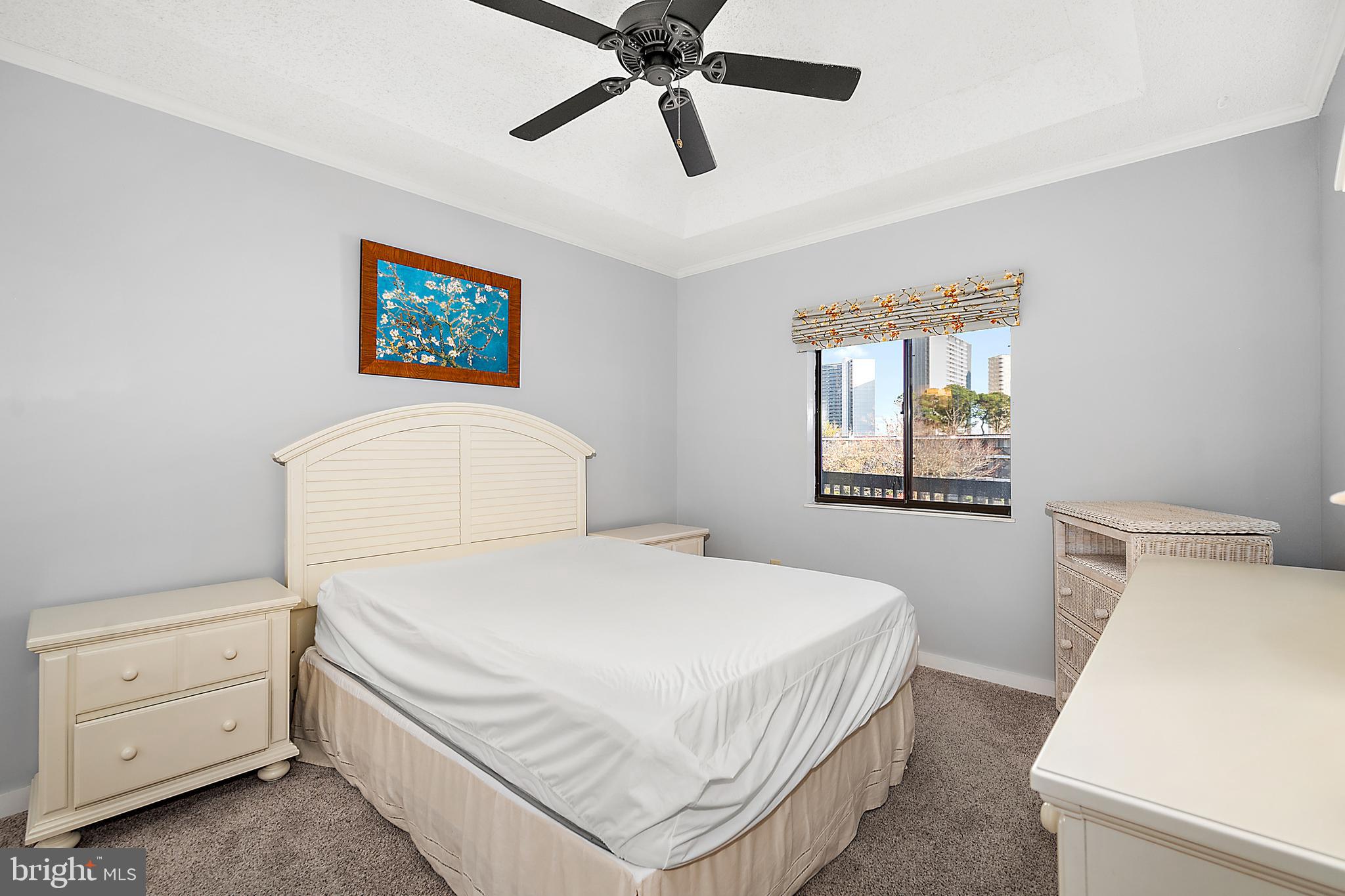 119 Old Landing Road, Unit 302B Ocean City, MD 21842 - Photo 30 of 46 a bedroom with a bed and a dresser