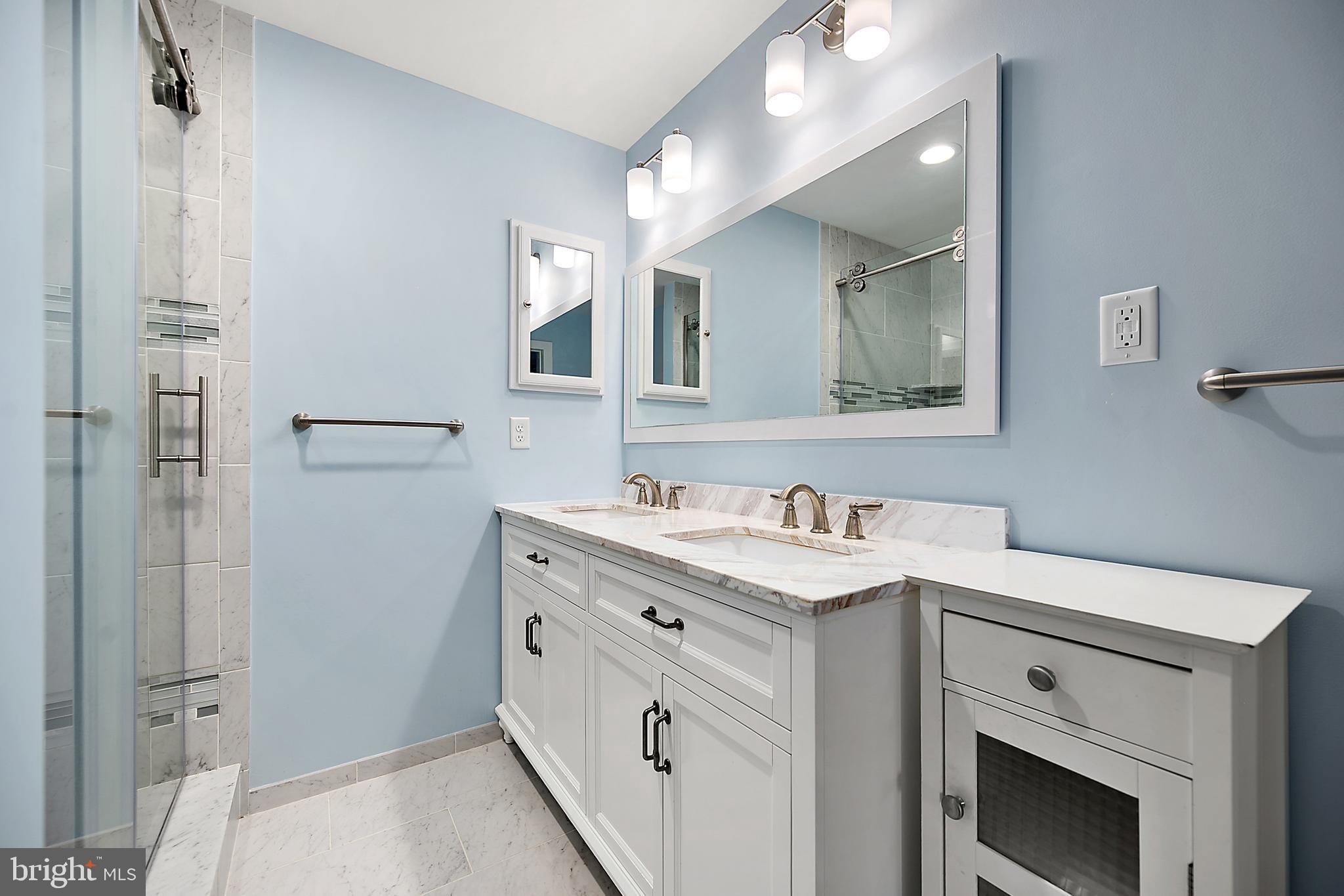 119 Old Landing Road, Unit 302B Ocean City, MD 21842 - Photo 33 of 46 a bathroom with a granite countertop sink vanity mirror and shower
