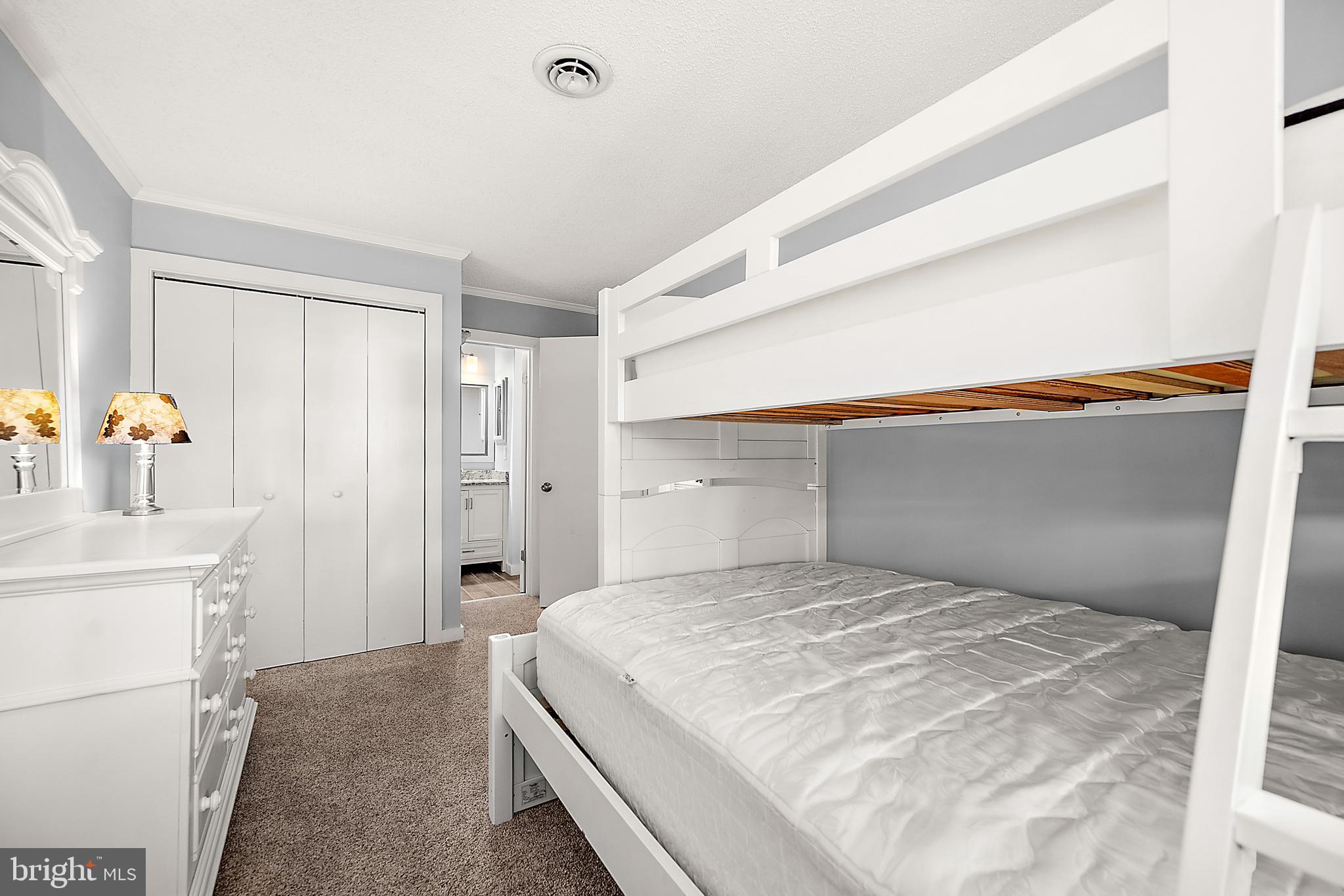 119 Old Landing Road, Unit 302B Ocean City, MD 21842 - Photo 36 of 46 a bedroom with a bed and a cabinets