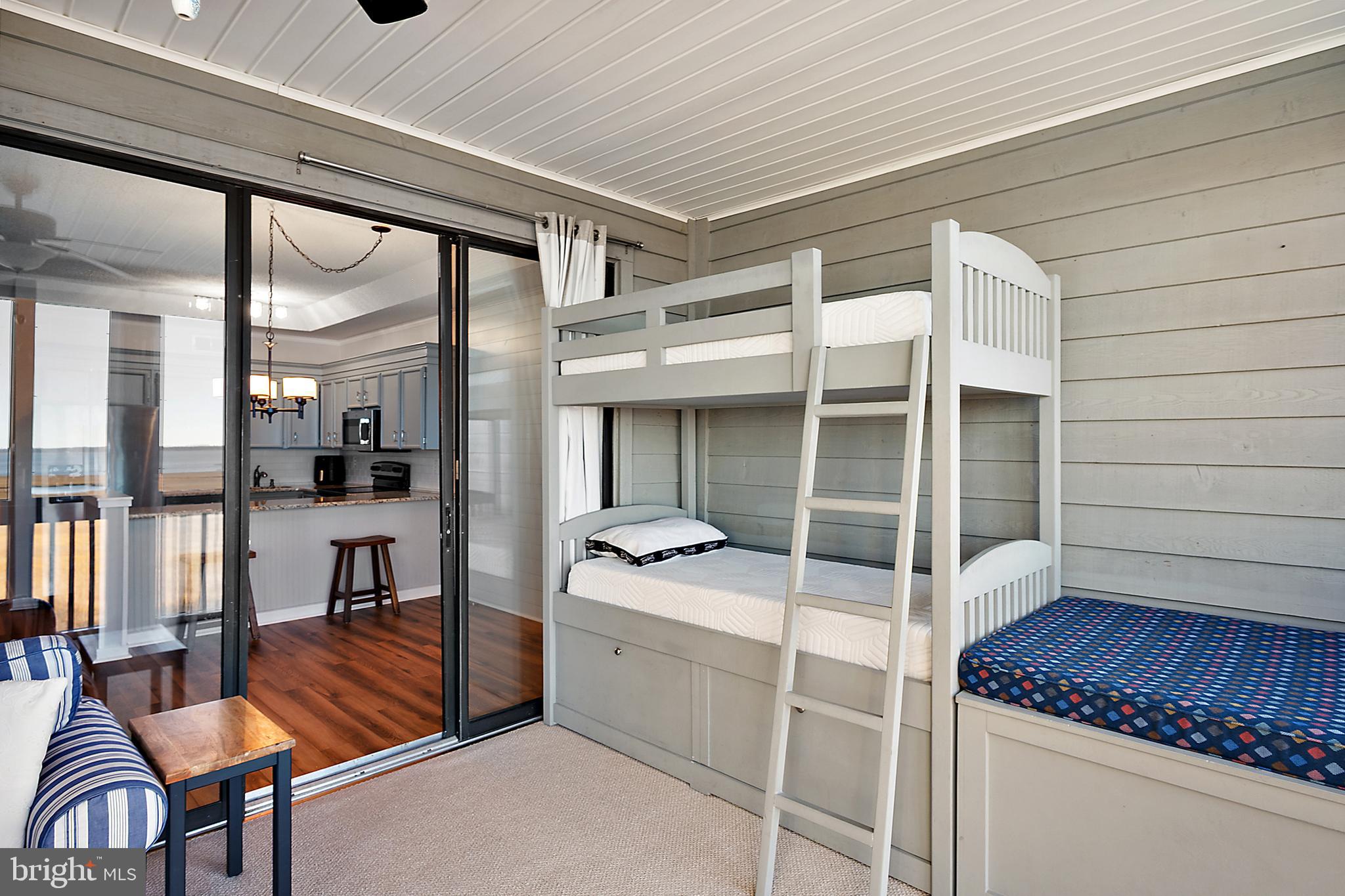 119 Old Landing Road, Unit 302B Ocean City, MD 21842 - Photo 40 of 46 a view of living room kitchen with furniture and large window
