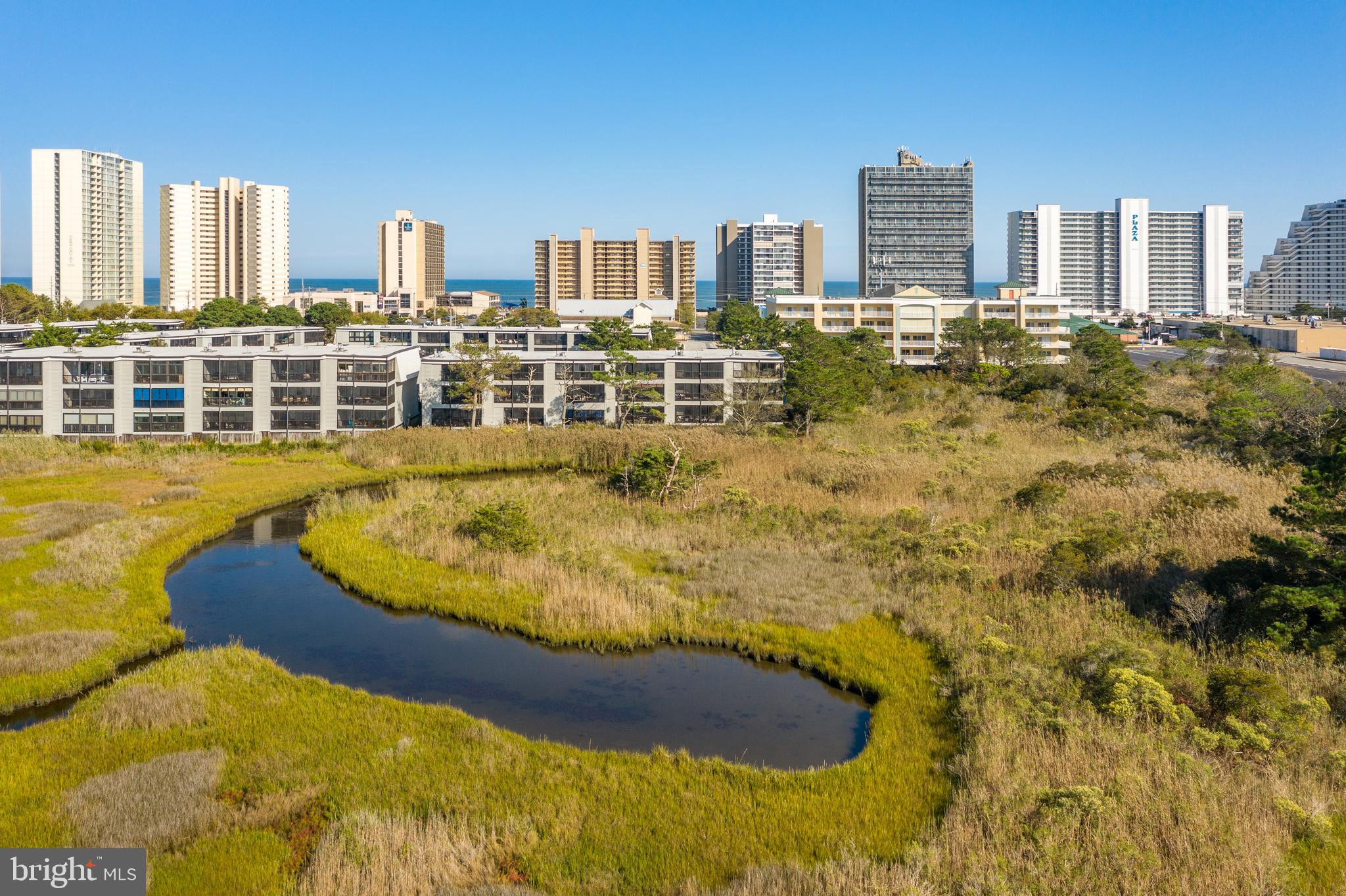 119 Old Landing Road, Unit 302B Ocean City, MD 21842 - Photo 45 of 46 a blue swimming pool with buildings in the background