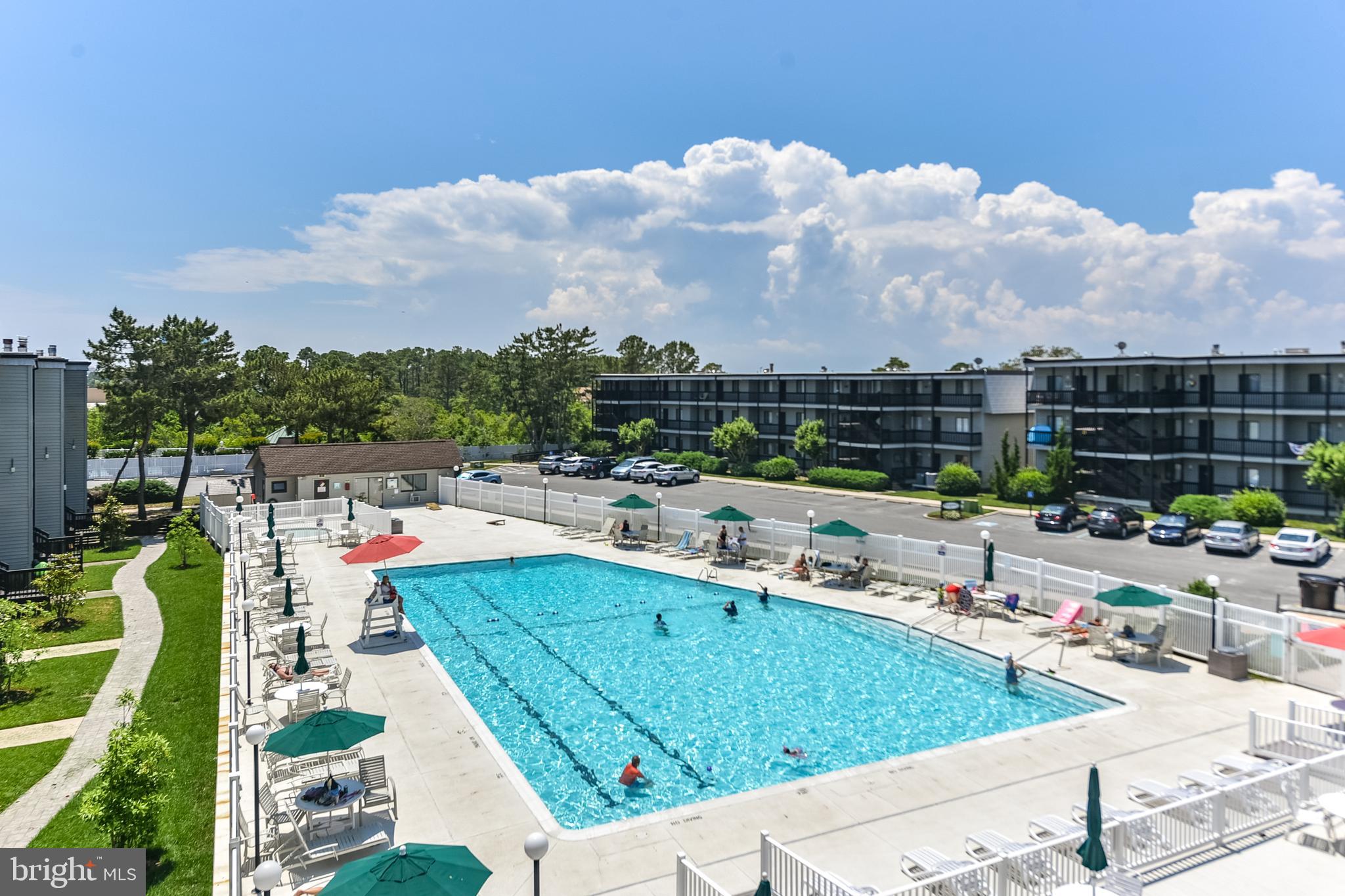 119 Old Landing Road, Unit 302B Ocean City, MD 21842 - Photo 10 of 46 a view of swimming pool with outdoor seating and a garden