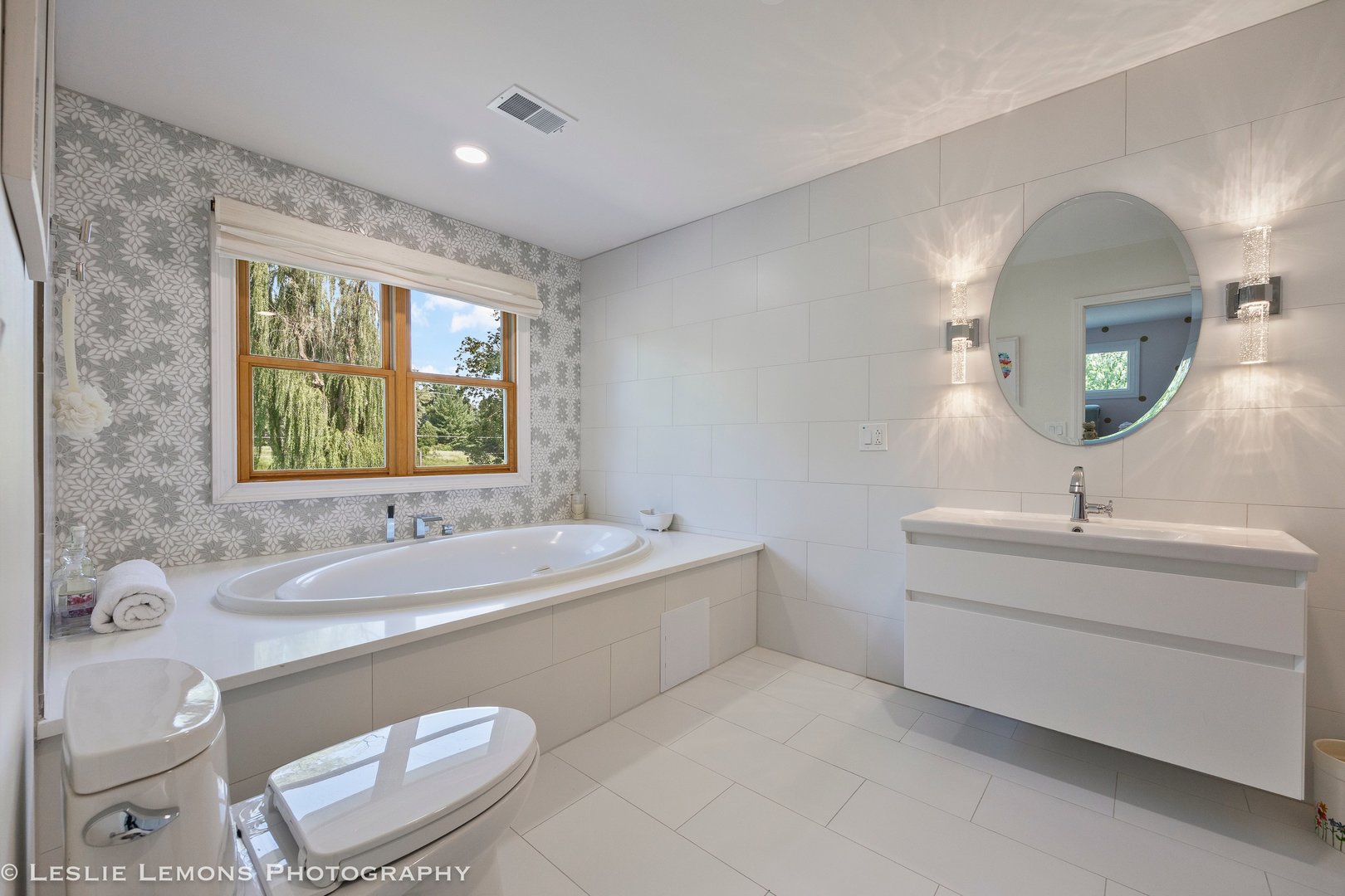 8S452 Bell Drive Naperville, IL 60565 - Photo 37 of 64 a spacious bathroom with a double vanity sink a mirror and a bathtub