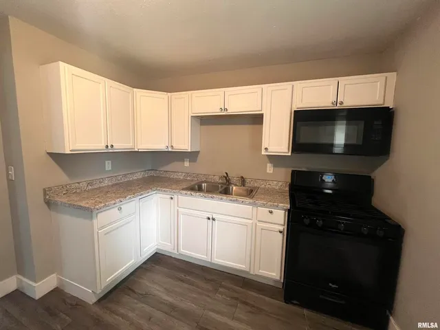 a kitchen with a sink and a stove top oven