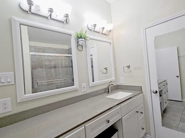 a bathroom with a sink double vanity and a mirror