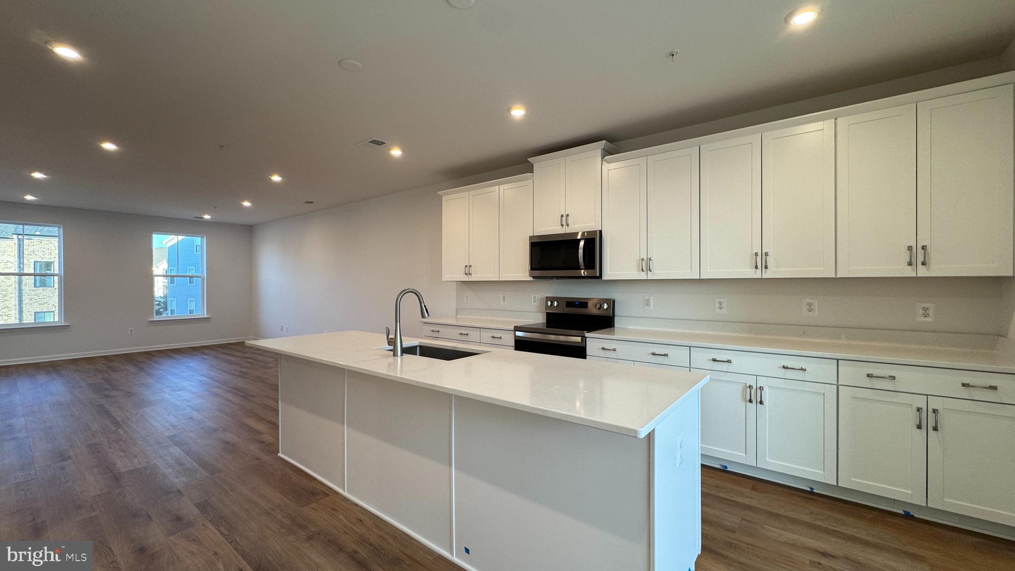 2623 River Birch Road Herndon, VA 20171 - Photo 5 of 12 a kitchen with a sink a microwave and cabinets
