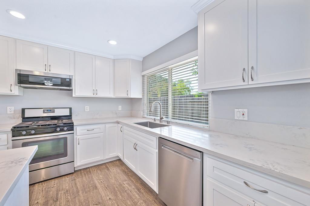 8037 Ruthwood Way Orangevale, CA 95662 - Photo 13 of 37 a kitchen with cabinets appliances a sink and a window