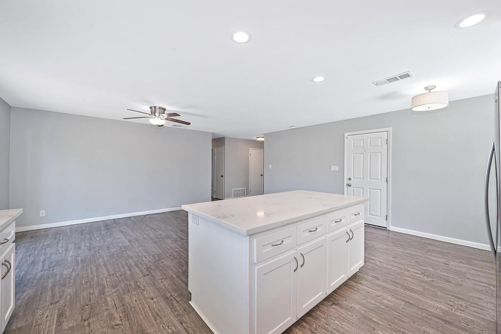 8037 Ruthwood Way Orangevale, CA 95662 - Photo 15 of 37 a hall with kitchen island white cabinets and wooden floor