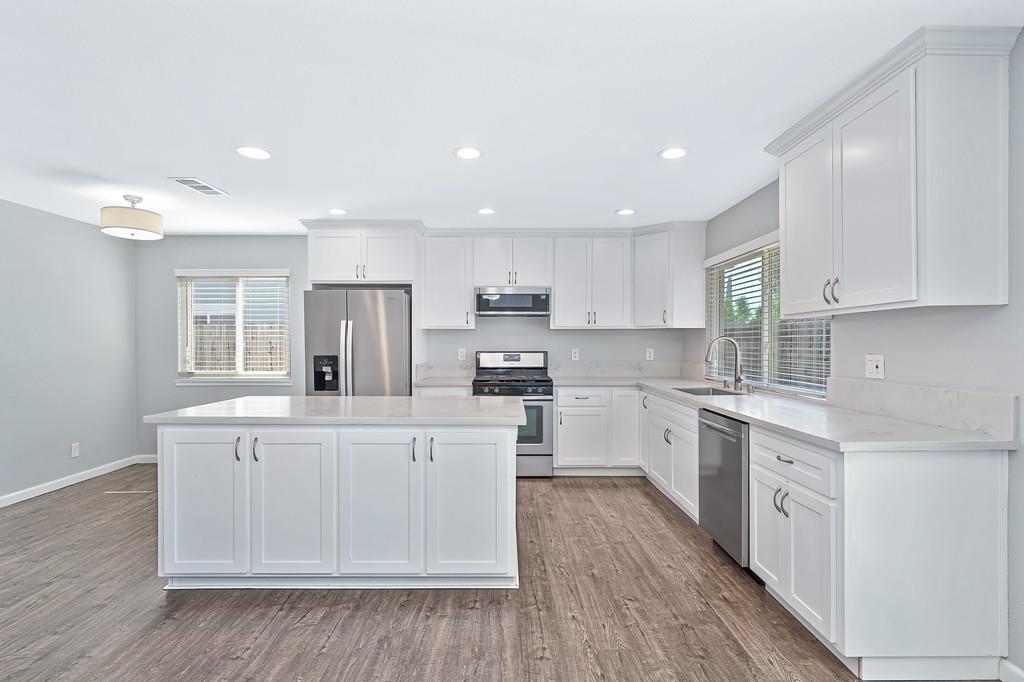 8037 Ruthwood Way Orangevale, CA 95662 - Photo 2 of 37 a kitchen with white cabinets stainless steel appliances and sink
