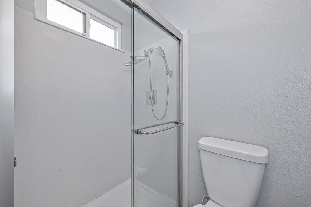 8037 Ruthwood Way Orangevale, CA 95662 - Photo 22 of 37 a bathroom with a granite countertop toilet and a shower