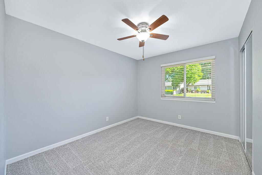 8037 Ruthwood Way Orangevale, CA 95662 - Photo 24 of 37 an empty room with windows and ceiling fan