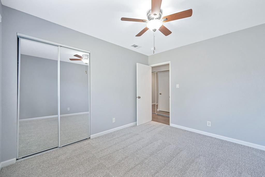 8037 Ruthwood Way Orangevale, CA 95662 - Photo 25 of 37 an empty room with a ceiling fan and a fan