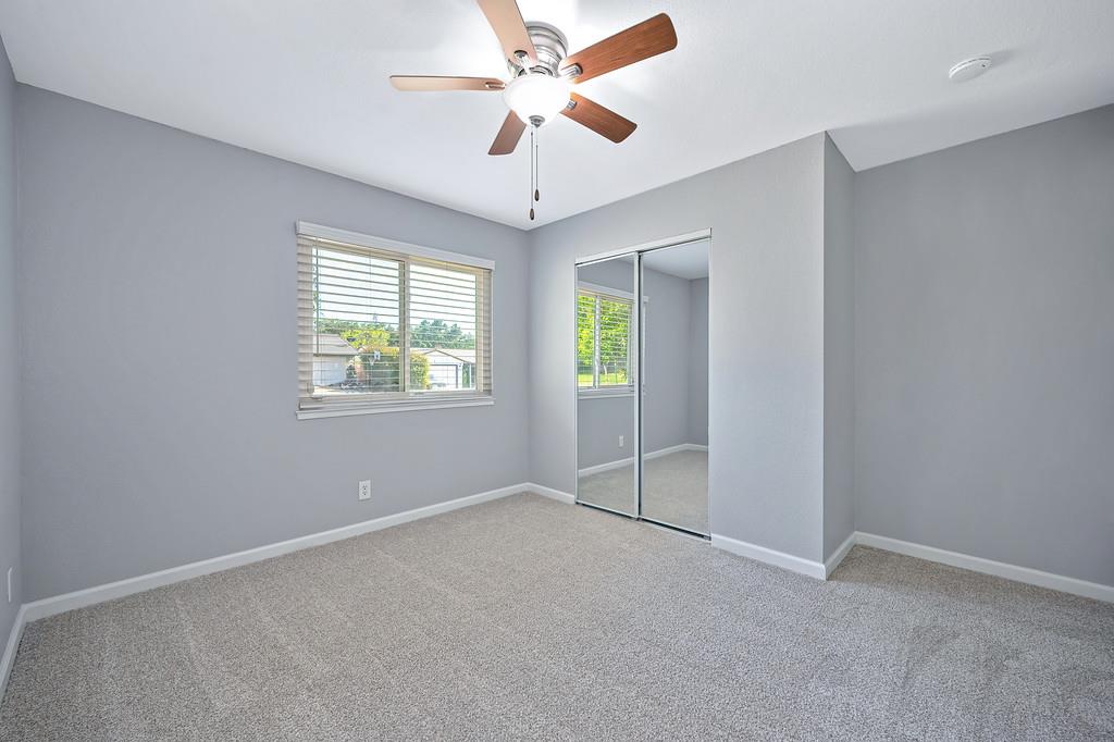 8037 Ruthwood Way Orangevale, CA 95662 - Photo 29 of 37 an empty room with windows and fan