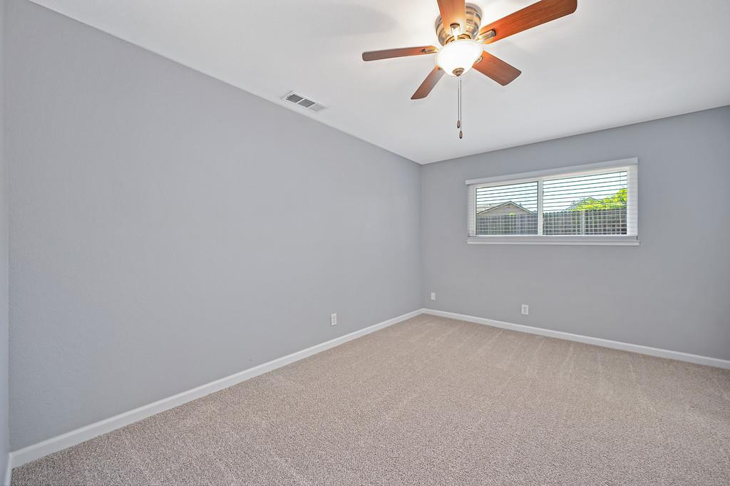 8037 Ruthwood Way Orangevale, CA 95662 - Photo 31 of 37 an empty room with windows and chandelier fan