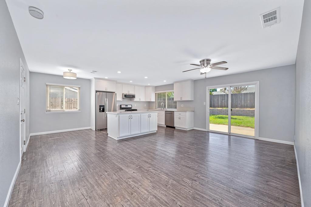 8037 Ruthwood Way Orangevale, CA 95662 - Photo 4 of 37 a view of an empty room with wooden floor and a window