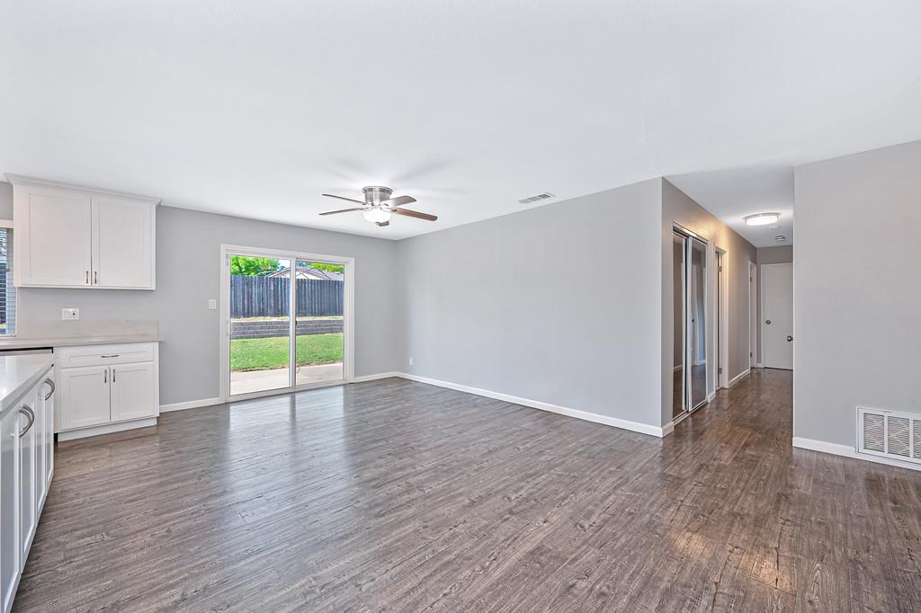 8037 Ruthwood Way Orangevale, CA 95662 - Photo 9 of 37 a view of an empty room with a window and wooden floor