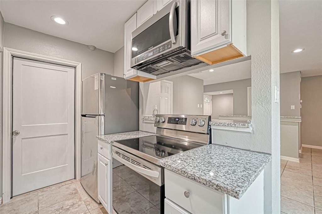 10252 Cottage Field Road Houston, TX 77041 - Photo 10 of 18 a kitchen with stainless steel appliances granite countertop a refrigerator and a sink