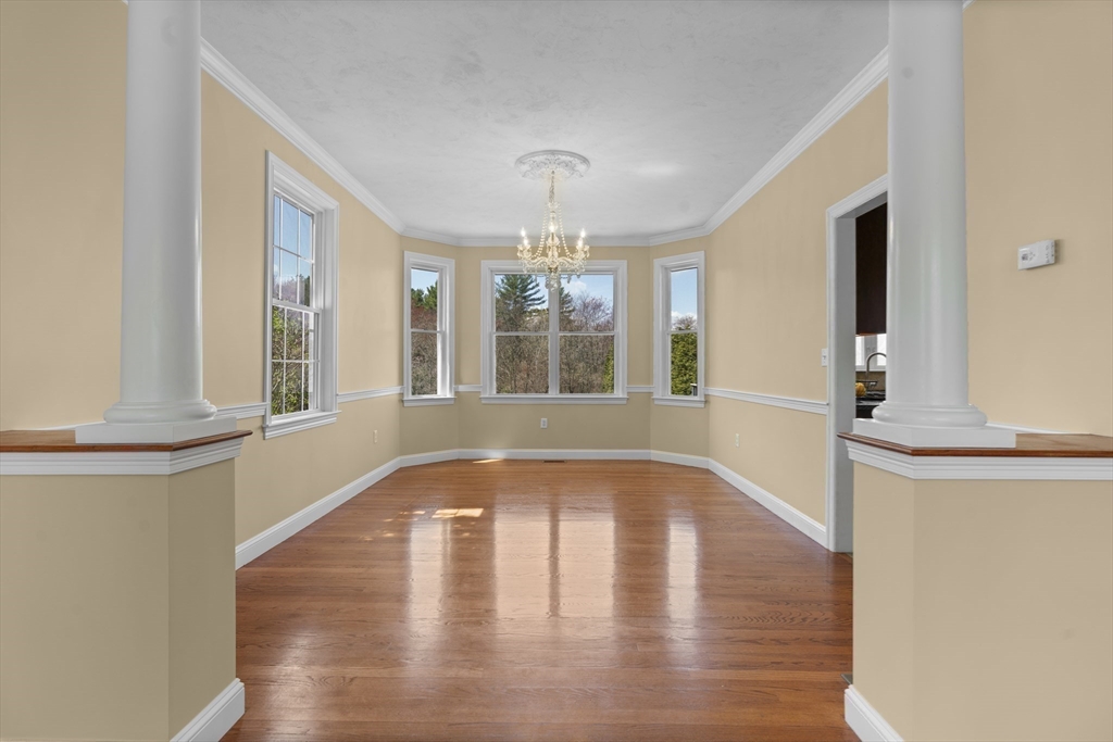 18 Ridgewood Street Ashland, MA 01721 - Photo 13 of 40 a view of an empty room with wooden floor and a window