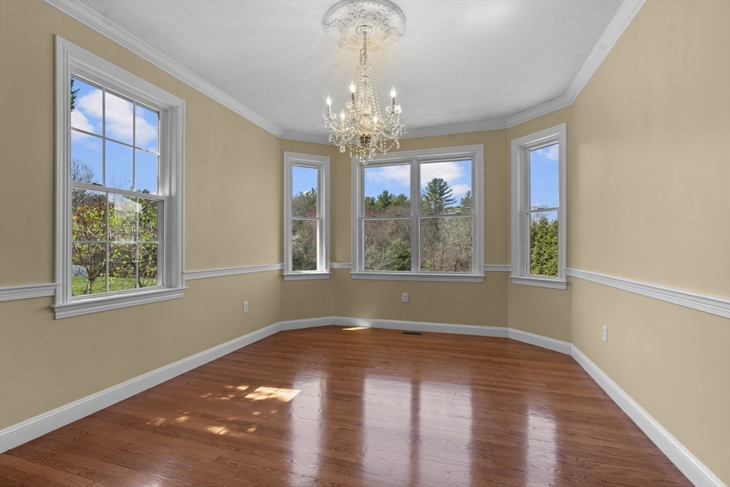 18 Ridgewood Street Ashland, MA 01721 - Photo 14 of 40 a view of an empty room with wooden floor and a window