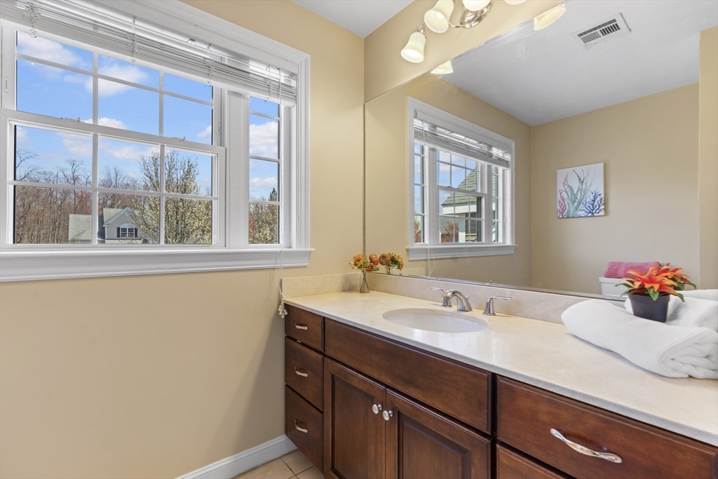 18 Ridgewood Street Ashland, MA 01721 - Photo 29 of 40 a bathroom with a sink mirror and a window