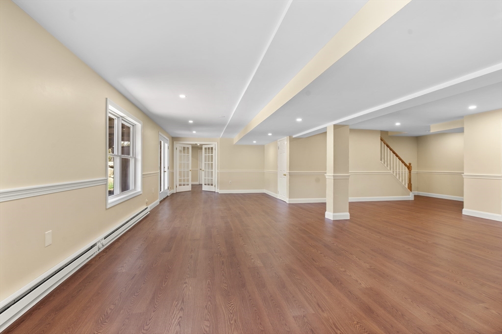 18 Ridgewood Street Ashland, MA 01721 - Photo 31 of 40 a view of an empty room with wooden floor and a window