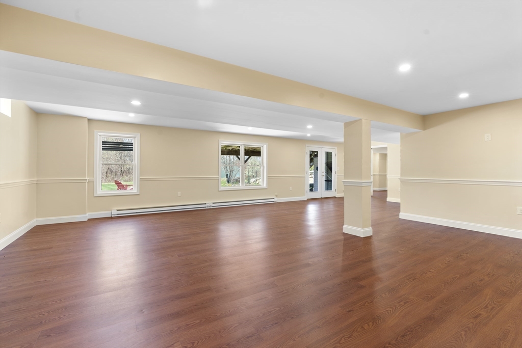 18 Ridgewood Street Ashland, MA 01721 - Photo 32 of 40 a view of empty room with wooden floor and windows