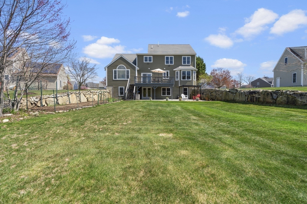 18 Ridgewood Street Ashland, MA 01721 - Photo 39 of 40 a view of a big house with a big yard and large trees