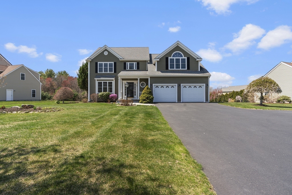 18 Ridgewood Street Ashland, MA 01721 - Photo 6 of 40 a view of a big house with a big yard and potted plants