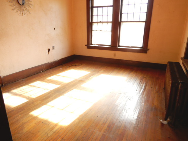 312 Union Street Joliet, IL 60433 - Photo 19 of 22 an empty room with wooden floor and windows