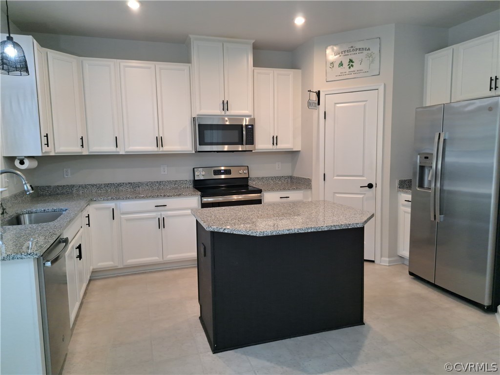 5300 Sandy Ridge Court Chesterfield, VA 23832 - Photo 18 of 39 a kitchen with stainless steel appliances granite countertop a sink a stove a refrigerator and white cabinets