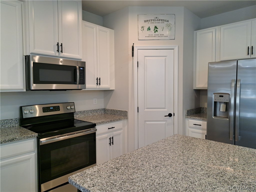 5300 Sandy Ridge Court Chesterfield, VA 23832 - Photo 20 of 39 a kitchen with stainless steel appliances granite countertop a refrigerator stove and microwave