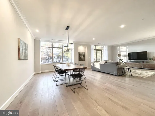 a spacious bathroom with a double vanity sink a mirror and a toilet
