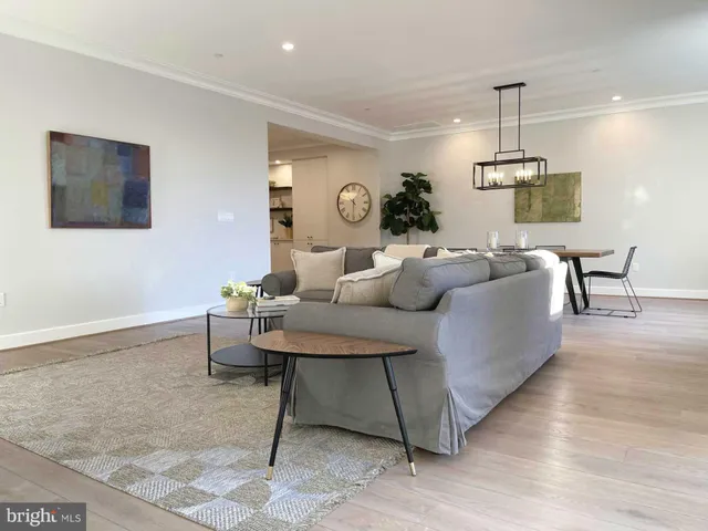 a living room with furniture and flowers
