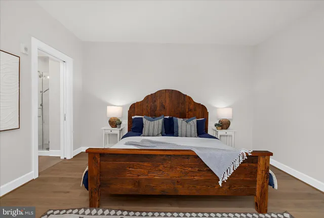 a living room with furniture and a painting on the wall