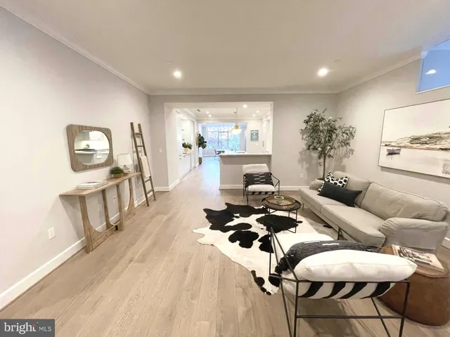 a large white kitchen with lots of counter space a sink appliances and cabinets
